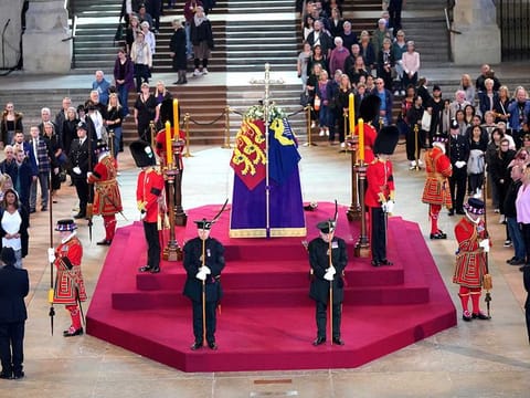Scottish Secretary Alister Jack and Secretary of State for Defence Ben Wallace in ceremonial role as members of the Royal Company of Archers guard the coffin of Queen Elizabeth II, draped in the Royal Standard with the Imperial State Crown and the Sovereign's orb and sceptre, lying in state on the catafalque in Westminster Hall, at the Palace of Westminster, London, ahead of her funeral on Thursday, September 15, 2022.  