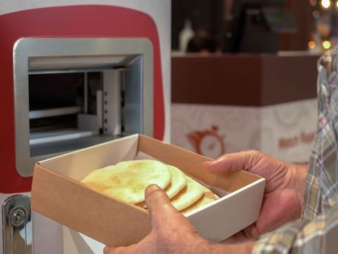 The machines are user-friendly, where any person in need can press the 'order' button. After a short wait, as the bread is being prepared, it will be dispensed from the machine