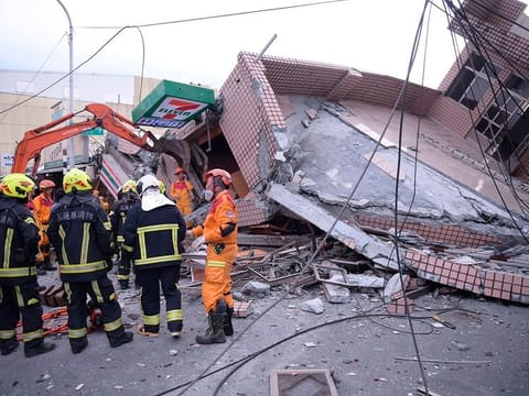 In this photo provided by Hualien City Government, firefighters are seen at a collapsed building during a rescue operation following an earthquake in Yuli township, Hualien County, eastern Taiwan on Sept. 18, 2022. 