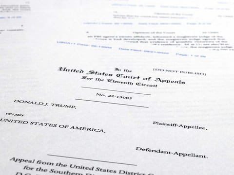 Pages from a U.S. Court of Appeals for the 11th Circuit in Atlanta ruling that lifts a judge's hold on the Justice Department's ability to use classified documents seized by the FBI at Trump's Mar-a-Lago estate, are photographed Wednesday, Sept. 21, 2022. 