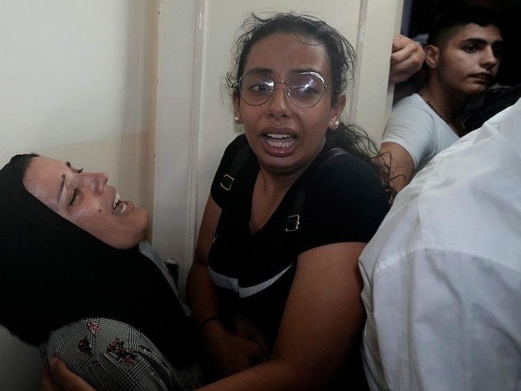 Relatives of two victims who were on a boat carrying migrants from Lebanon that sank in Syrian waters, mourn at their house after they bring back home their bodies, in Tripoli, north Lebanon, September 23, 2022. 