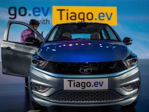 A journalist takes picture of Tata Tiago EV electric car during its global launch in Mumbai, India, Wednesday, Sept. 28, 2022. 