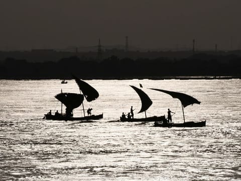 A view of boats silhouette, in the River Indus, following rains and floods during the monsoon season in Jamshoro, Pakistan, on September 20, 2022.  