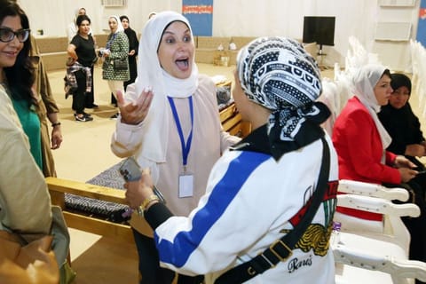 Kuwaiti candidate Jenan Bu Shehri  celebrates with her supporters following the announcement of her victory in the parliamentary elections, in Kuwait city, early on September 30, 2022.  