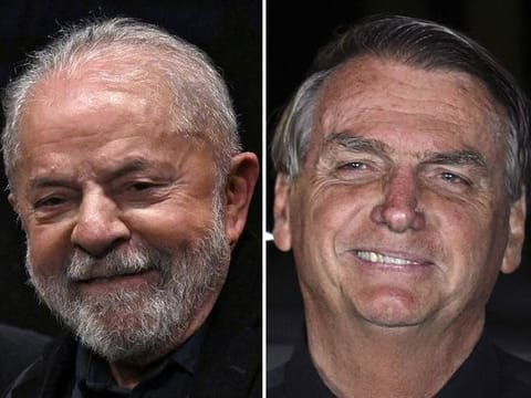 Brazilian former President (2003-2010) and candidate for the leftist Workers Party (PT), Luiz Inacio Lula Da Silva (L),  Brazilian President and re-election candidate Jair Bolsonaro smiling after the results of election were announced, in Brasilia, on October 2, 2022