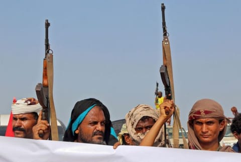 Militants gather for a protest against Yemen's Al Houthi militia in the Khokha region of the country's war-ravaged western province of Hodeida. 