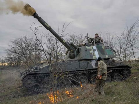 Ukrainian artillery unit members fire towards Kherson on October 28, 2022, outside of Kherson region, amid Russia's military attack on Ukraine. 