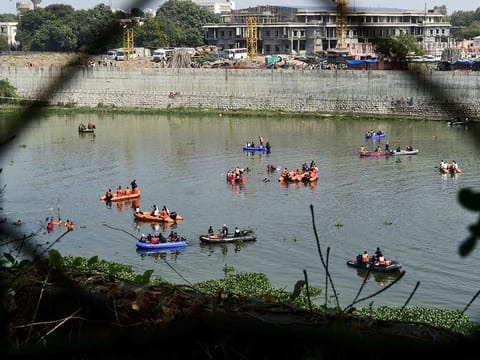 Rescue personnel conduct search operations after a bridge across the river Machchhu collapsed at Morbi in India's Gujarat state on October 31, 2022.  