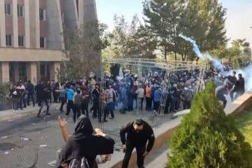 Protesters avoiding projectiles during clashes at Iran's University of North Tehran.  
