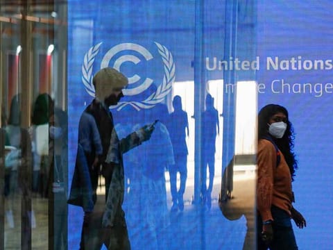 Participants walk at the Sharm Al Sheikh International Convention Centre, on the first day of the COP27 climate summit, in Egypt's Red Sea resort city of Sharm Al Sheikh, on November 6, 2022. 
