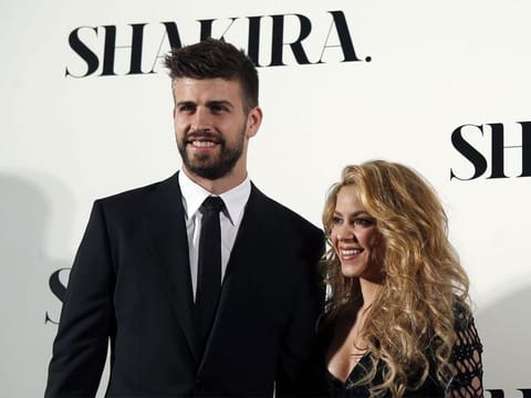 Colombian singer Shakira and FC Barcelona's soccer player Gerard Pique (L) pose during a photocall presenting her new album "Shakira" in Barcelona March 20, 2014. 