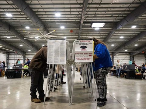 Voters fill out their ballots at the Flathead County Fairgrounds in Kalispell, Montana, Tuesday, Nov. 8, 2022. 