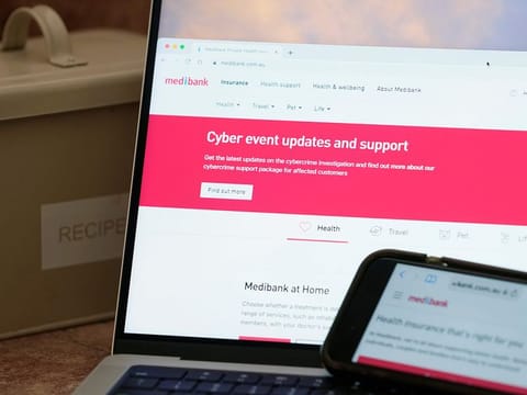 A computer and phone display pages from Medibank Private in Sydney. 