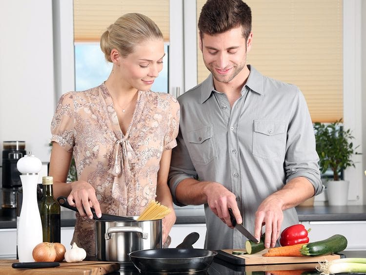 A couple preparing food in the kitchen