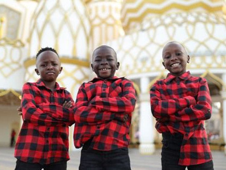 Prince, Jonbosco and Mohammed are all smiles as they pose for pictures at Global Village.