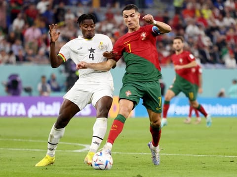 Ghana's Mohammed Salisu concedes a penalty against Portugal's Cristiano Ronaldo. Ronaldo scored to become the first player to score in five different World Cup finals. 