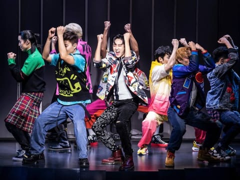 This image released by O+M/DKC shows Kevin Woo, center, and the cast during a performance of “KPOP,” opening November 27 at the Circle in the Square Theatre in New York. 