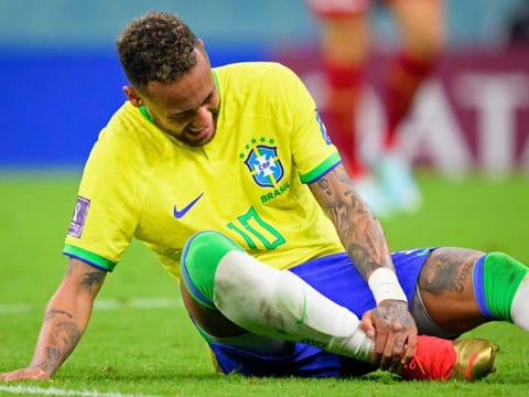 Brazil's Neymar grabs his ankle after an injury during the World Cup Group G match against Serbia.