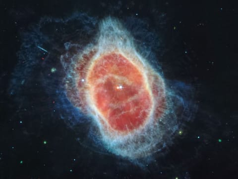  James Webb Space Telescope (JWST) has revealed the cloak of dust around the second star, shown at left in red, at the center of the Southern Ring Nebula.