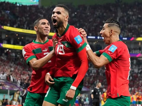 A HERO: Youssef En-Nesyri (centre) celebrates after scoring Morocco’s winning goal against Portugal in the FIFA World Cup Qatar 2022 quarterfinal football match at the Al Thumama Stadium in Doha on December 10, 2022. Morocco became the first African nation to enter the last four. 