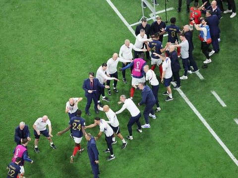 France players are congratulated by staff member as they leave the pitch after they won the Qatar World Cup semi-final match against Morocco at the Al Bayt Stadium in Al Khor, north of Doha on December 14, 2022. 