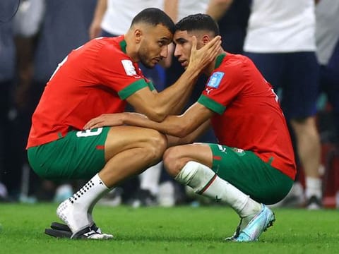 Morocco’s Romain Saiss and Achraf Hakimi console each other after being eliminated from the FIFA World Cup Qatar 2022, following the defeat to France in the semifinal at the Al Bayt Stadium in Al Khor, 50km north of Doha, on December 14, 2022. France won 2-0. 