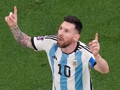Argentina's Lionel Messi celebrates scoring his side's first goal during the World Cup final soccer match between Argentina and France.