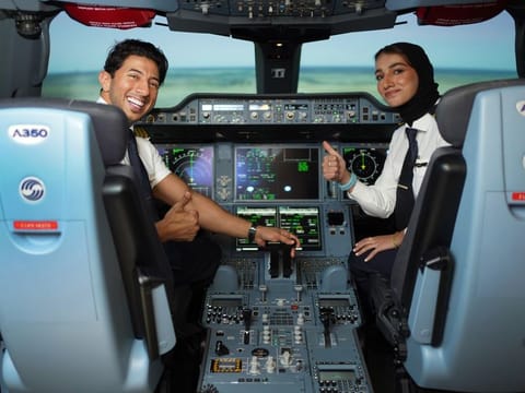 Captain Abdulla M. Al Afeefi (left), Captain A320, Etihad Airways, and Aya Alaudhli, Second Officer B787, Etihad Airways, inside a flight simulator 