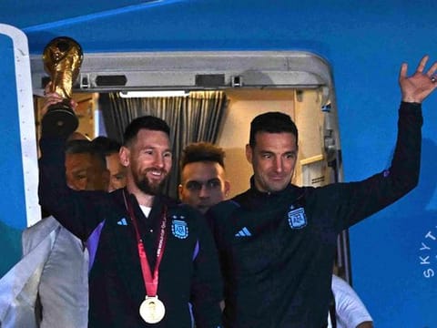 Claudio Tapia, president of the Argentine Football Association and Lionel Messi with the trophy during the team's arrival at Ezeiza International Airport. 