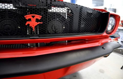 The front grille of an electrified 1965 Ford Mustang is seen at Inspire EV's garage in Arvada, Colo..A small but expanding group of tinkerers, racers, engineers, and entrepreneurs across the country are converting vintage cars and trucks into greener, often much faster, electric vehicles.