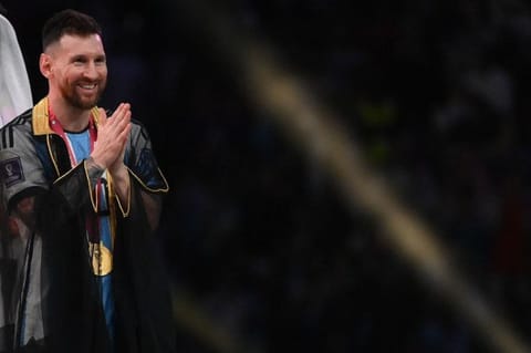 Messi gestures during the Qatar 2022 World Cup trophy ceremony 