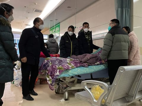 A man pulls a cloth to cover up the face of an elderly woman whose vitals flatlined as emotional relatives gather silently around her for a final farewell before her body is taken away at the emergency department of the Langfang No. 4 People's Hospital in Bazhou city in northern China's Hebei province on Thursday, Dec. 22, 2022. As China grapples with its first-ever wave of COVID mass infections, emergency wards in the towns and cities to Beijing's southwest are overwhelmed. Intensive care units are turning away ambulances, residents are driving sick relatives from hospital to hospital, and patients are lying on floors for a lack of space. (AP Photo)
