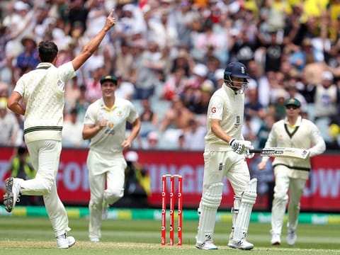Joe Root walking back after being dismissed by Mitchell Starc.