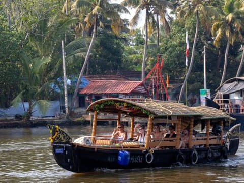A small traditional Indian boat takes a group of young western tourists on a cruise on the Alleppey backwaters in the southern state of Kerala.