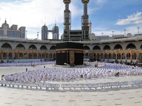 Rows of worshippers pray at the Grand Mosque in Mecca on December 30, 2021, following the imposition of new restrictions due to a surge in COVID-19 cases. 