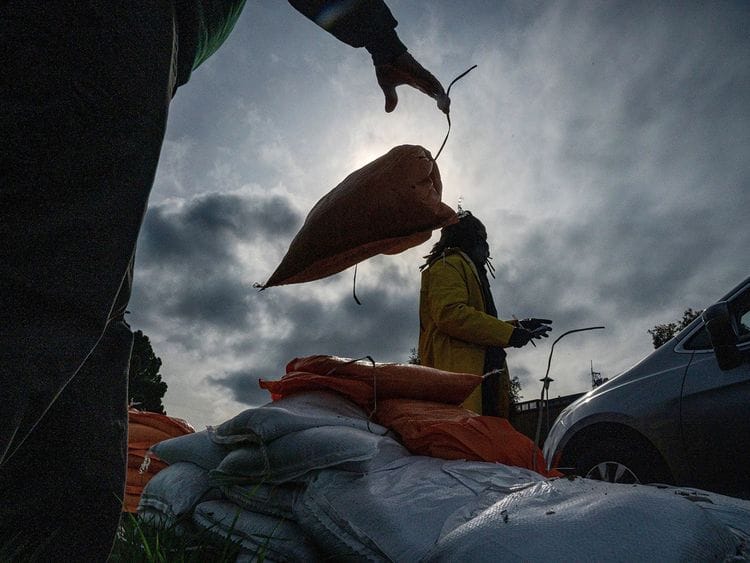 City of Oakland workers distribute sandbags to residents ahead of a rain storm in Oakland, California, US, on Tuesday. 