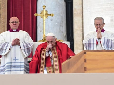 Pope Francis prays by the coffin of Pope Emeritus Benedict XVI during his funeral mass at St. Peter's square in the Vatican, on January 5, 2023.