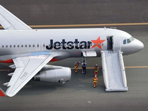 An aerial view shows a Jetstar plane after the budget carrier made an emergency landing following a bomb threat at Chubu Centrair International Airport in Tokoname, central Japan. 