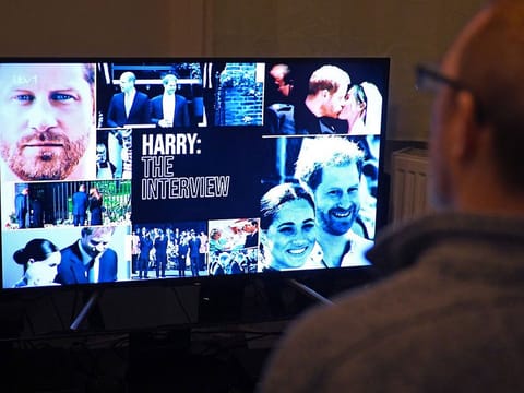  A member of the public poses in his front room in Manchester, north-west England, watching a television interview broadcast on ITV, being given by Britain's Prince Harry, Duke of Sussex on January 8, 2023, ahead of the publication of his book, 'Spare'.