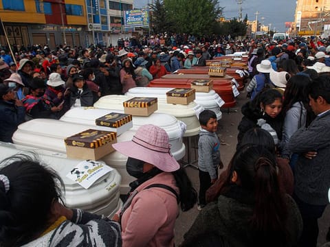Relatives of 18 people killed in clashes with security forces wait with empty coffins outside the morgue of the Carlos Monge Medrano hospital in Juliaca, southern Peru.