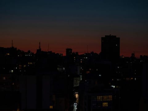 The capital city of Beirut remains in darkness during a power outage as the sun sets.