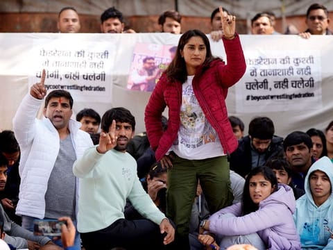 Wrestler Vinesh Phogat (red jacket), Tokyo Olympics medallist Bajrang Punia (second left), and other wrestlers participate in a protest against Wrestling Federation of India President Brijbhushan Sharan Singh and other officials in New Delhi, India, on January 20, 2023. They accused the federation president and coaches of sexually and mentally harassing young wrestlers. 