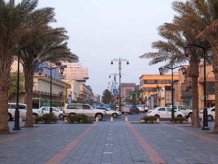 Stock Saudi Jeddah Corniche palms and traffic in the back at sunset