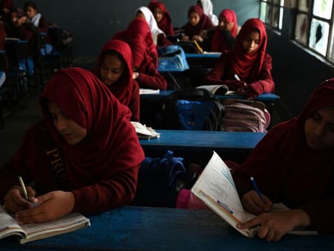 Students attend a class at a government high secondary school during a nationwide power outage in Rawalpindi on January 23, 2023. A massive power breakdown in Pakistan on January 23 affected most of the country's more than 220 million people, including in the mega cities of Karachi and Lahore.