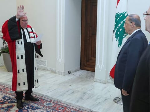 Lebanese Judge Ghassan Ouweidat (left) during his swearing-in ceremony before Lebanese President Michel Aoun at the presidential palace of Baabda, east of the capital on September 17, 2019.  