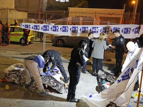 Graphic content: Israeli emergency personnel help victims at the site of a reported attack in a settler neighbourhood in East Jerusalem on January 27, 2023. 