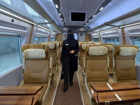 Saudi conductor Tharaa Ali in one of the wagons of a high-speed train ferrying pilgrims to Mecca.