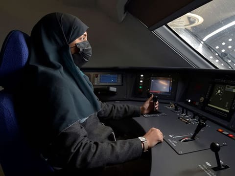 Saudi conductor Raneem Azzouz drives a high-speed train ferrying pilgrims to Mecca.