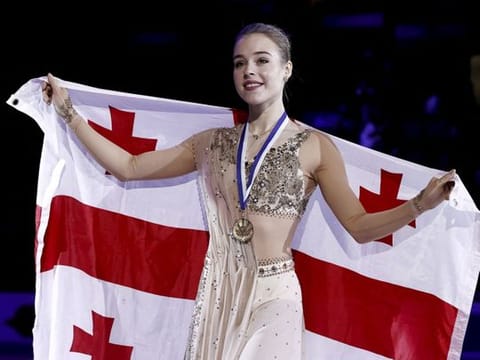 Gold medallist Georgia's Anastasiia Gubanova celebrates on the podium after winning the women's free skating