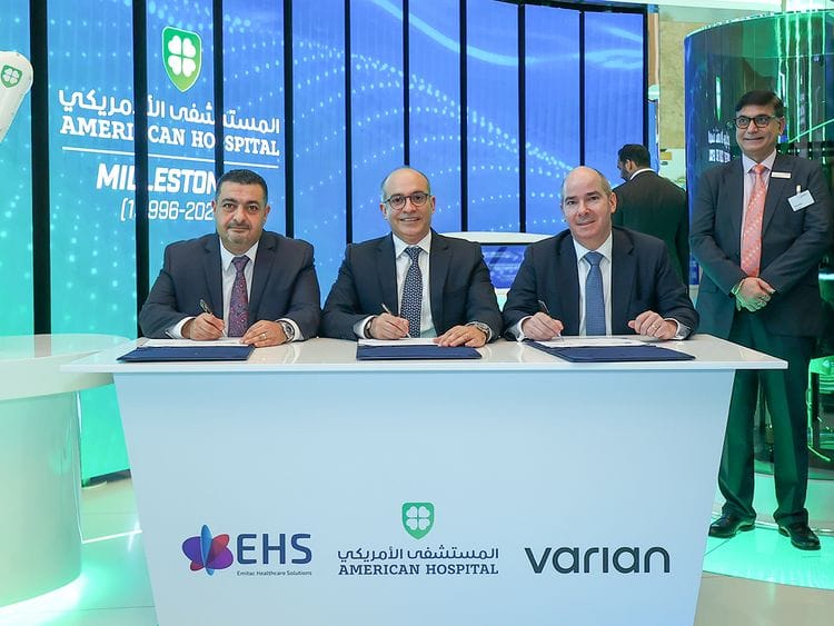 Sherif Beshara, CEO of American Hospital Dubai (centre);  Mohammed Kenanah (left), CEO of Emitac Healthcare Solutions; and Laurent Amiel, President, Radiation Oncology Solutions, Europe, Middle East and Africa at Varian, signed the agreement at Arab Health